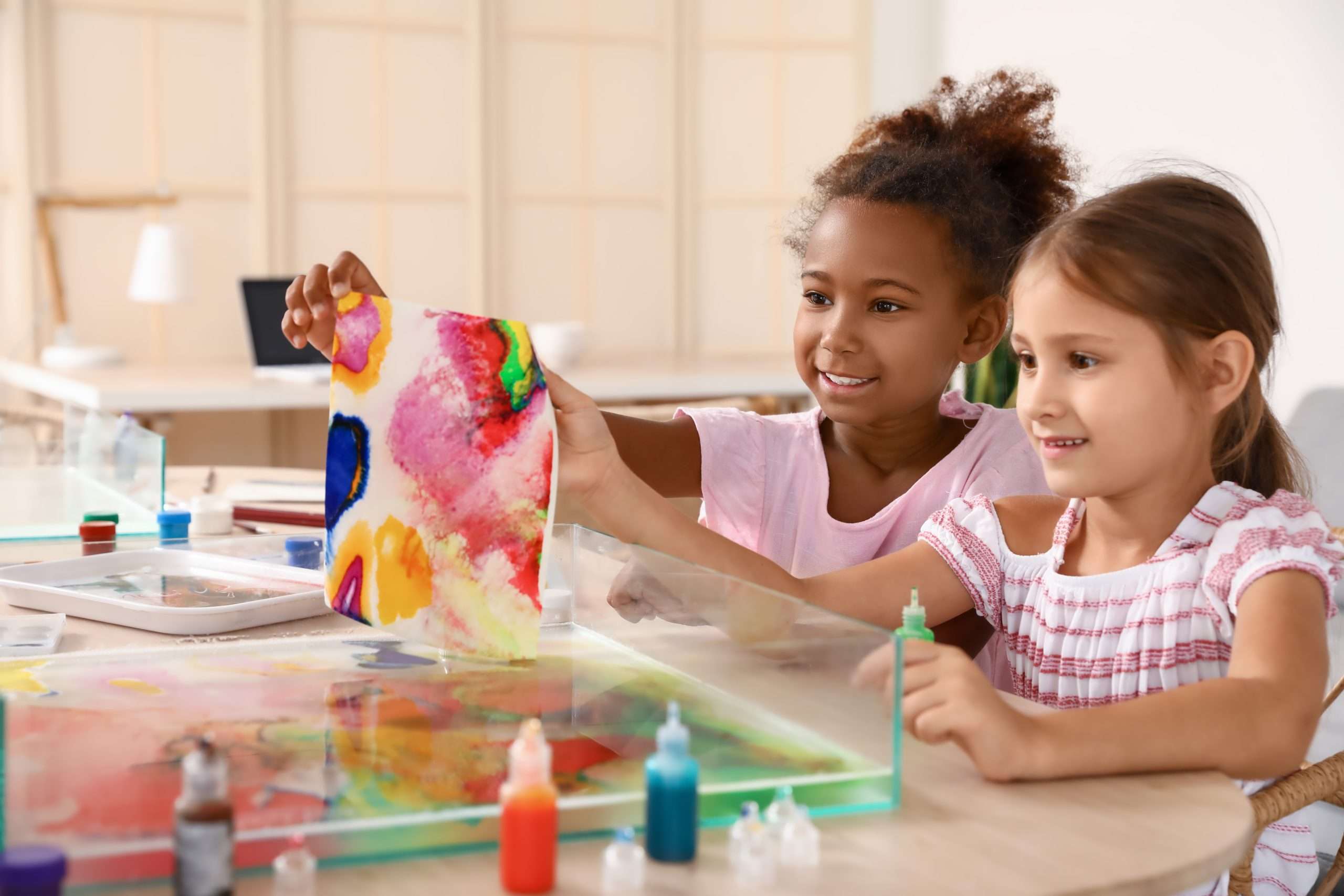 Little children marbling paper during master class in Ebru painting school aged children working on artwork arts scholarship the libfund